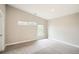 Bright bedroom with gray carpet, white trim, large windows and vaulted ceilings provides ample natural light at 1533 S Columbine St, Denver, CO 80210