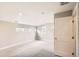 A spacious bedroom with gray carpet, light walls, recessed lighting and multiple windows providing ample natural light at 1533 S Columbine St, Denver, CO 80210