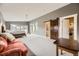 Expansive bedroom featuring attached full bathroom, laundry area, and barn door at 1533 S Columbine St, Denver, CO 80210