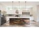Modern kitchen featuring stainless steel appliances, marble countertops, and a stylish wood-paneled island at 1533 S Columbine St, Denver, CO 80210