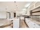 Bright, modern kitchen with white cabinets, a marble island, and stainless steel appliances at 1533 S Columbine St, Denver, CO 80210