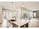 Bright kitchen with marble countertops, an island with a sink, and large sliding doors that open onto a patio at 1533 S Columbine St, Denver, CO 80210