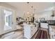 Open kitchen with marble island, stainless steel appliances, and easy access to the living area at 1533 S Columbine St, Denver, CO 80210