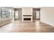 Bright living room featuring wood floors, a modern fireplace, and large windows offering plenty of natural light at 1533 S Columbine St, Denver, CO 80210