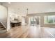 Open concept living space with hardwood floors, modern lighting, and seamless transitions to the kitchen and outdoor spaces at 1533 S Columbine St, Denver, CO 80210