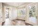 Bright room featuring hardwood floors, large windows, and access to an outdoor deck at 1533 S Columbine St, Denver, CO 80210