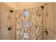 Walk-in shower featuring marble-patterned tile and glass block window accents at 1533 S Columbine St, Denver, CO 80210