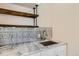 Stylish sink area with marble countertop and decorative tile backsplash at 1533 S Columbine St, Denver, CO 80210