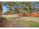 Spacious backyard with mature trees, a wooden fence, and wildlife at 30321 Chestnut Dr, Evergreen, CO 80439