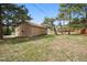 The backyard features a detached garage, trees, and lawn at 30321 Chestnut Dr, Evergreen, CO 80439