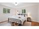 Cozy bedroom featuring two windows providing natural light and modern decor at 30321 Chestnut Dr, Evergreen, CO 80439