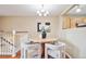 Cozy dining area featuring a round table, stylish chairs, and a modern chandelier, perfect for intimate gatherings at 30321 Chestnut Dr, Evergreen, CO 80439