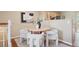 Bright dining area with a round wooden table, fashionable seating, and an open view of the adjoining kitchen at 30321 Chestnut Dr, Evergreen, CO 80439