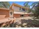 Charming two-story home featuring a brick facade, well-maintained lawn, and a welcoming front door with decorative wreath at 30321 Chestnut Dr, Evergreen, CO 80439