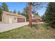 Two-car garages on house and detached, expansive driveway, on a wooded lot at 30321 Chestnut Dr, Evergreen, CO 80439