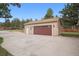 Detached garage with brown doors, offering ample parking and storage space at 30321 Chestnut Dr, Evergreen, CO 80439