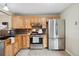 Bright kitchen with stainless steel appliances, wood cabinets, and tile flooring at 30321 Chestnut Dr, Evergreen, CO 80439