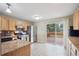 Open concept kitchen with wood cabinetry, stainless appliances, and sliding glass door to outdoor deck at 30321 Chestnut Dr, Evergreen, CO 80439