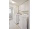 Efficient laundry room with full-size washer and dryer, adjacent shower, and tiled floor at 30321 Chestnut Dr, Evergreen, CO 80439