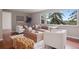 Bright living room featuring a stylish sofa, cozy armchairs, natural light, and a view at 30321 Chestnut Dr, Evergreen, CO 80439