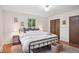 Bright main bedroom featuring hardwood floors, neutral walls, area rug and a large window at 30321 Chestnut Dr, Evergreen, CO 80439