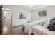 Bright main bedroom with hardwood floors, neutral walls, area rug and a large window at 30321 Chestnut Dr, Evergreen, CO 80439