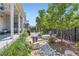 Cozy backyard featuring a stone firepit, rock garden, and covered patio at 11253 Moondance Trl, Littleton, CO 80125