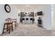 Finished basement boasts a bar area, with a TV and seating for guests at 11253 Moondance Trl, Littleton, CO 80125