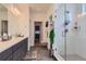Spacious bathroom with glass-enclosed shower and double vanity with grey cabinets at 11253 Moondance Trl, Littleton, CO 80125