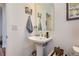 Charming powder room features pedestal sink and stylish decor, creating a welcoming space at 11253 Moondance Trl, Littleton, CO 80125