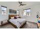 Bedroom with wooden headboard and three large windows offering great natural light at 11253 Moondance Trl, Littleton, CO 80125