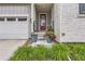 Welcoming front porch with a red door, beautiful plants, and stone accents at 11253 Moondance Trl, Littleton, CO 80125