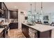 Gourmet kitchen with quartz countertops, dark wood cabinets, and stainless steel appliances at 11253 Moondance Trl, Littleton, CO 80125