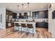 Stylish kitchen featuring a large island, pendant lighting, and stainless steel appliances at 11253 Moondance Trl, Littleton, CO 80125