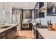 Modern kitchen with stainless steel appliances, white countertops and dark cabinets at 11253 Moondance Trl, Littleton, CO 80125