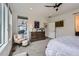 Bright main bedroom with an upholstered chair and large dresser at 11253 Moondance Trl, Littleton, CO 80125