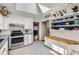 Bright kitchen with white cabinets, stainless steel appliances, and a skylight at 1284 S Elizabeth St, Denver, CO 80210