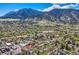 Stunning aerial view of the property nestled in a lush, green neighborhood with a mountain backdrop at 753 Pearl St, Boulder, CO 80302