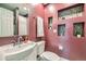 Stylish bathroom showcasing a modern sink, toilet, decorative wall niches, and maroon walls at 753 Pearl St, Boulder, CO 80302