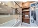 Bathroom features tiled shower with glass door, built in shelving, and modern lighting at 753 Pearl St, Boulder, CO 80302