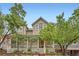 Charming two-story home with a welcoming front porch and mature trees at 753 Pearl St, Boulder, CO 80302