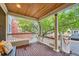 Inviting covered porch featuring a wooden ceiling, white pillars and railings at 753 Pearl St, Boulder, CO 80302