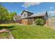 Lush backyard with a well-maintained lawn, privacy fence, and a covered patio area at 9494 Devonshire Pl, Highlands Ranch, CO 80126