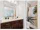 Bathroom with a modern vanity, mirror, and a shower over the bath with tropical themed shower curtain at 9494 Devonshire Pl, Highlands Ranch, CO 80126