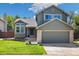 Charming two-story home with a well-maintained lawn and attached two-car garage at 9494 Devonshire Pl, Highlands Ranch, CO 80126