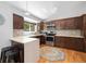 Modern kitchen with stainless steel appliances, dark wood cabinetry, and quartz countertops at 9494 Devonshire Pl, Highlands Ranch, CO 80126
