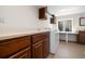 Functional laundry room with spacious countertop, ample cabinets, and a large window for natural light at 9494 Devonshire Pl, Highlands Ranch, CO 80126