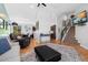 Inviting living room featuring hardwood floors, a cozy seating area, and a staircase at 9494 Devonshire Pl, Highlands Ranch, CO 80126