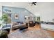 Bright living room with high ceilings, stylish decor, and hardwood floors at 9494 Devonshire Pl, Highlands Ranch, CO 80126