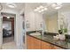 Well-lit bathroom with a single vanity sink, granite countertops, and laundry facilities at 640 11Th St # 302, Golden, CO 80401